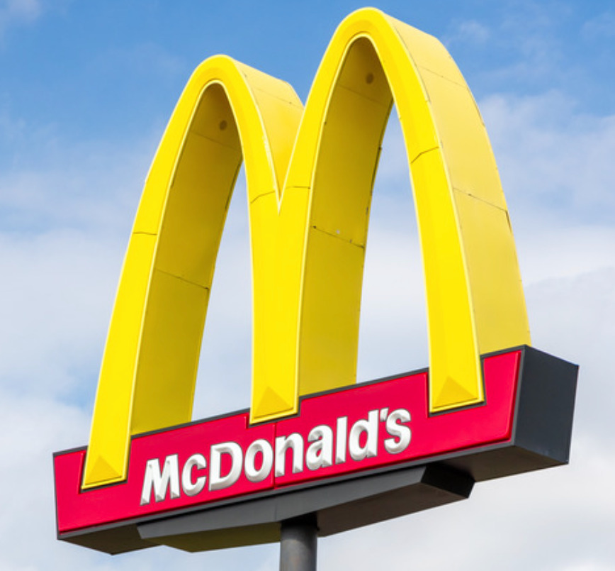 Close up photo of McDonald's golden arches yellow and red logo supporting the idea that fast food restaurants colour to make us hungry